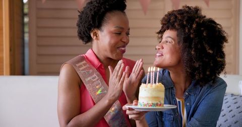 Joyful Diverse Female Couple Celebrating Birthday with Cake
