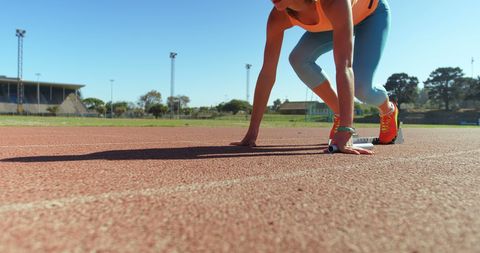 Female Athlete Preparing for Sprint on Track Field - Download Free Stock Images Pikwizard.com