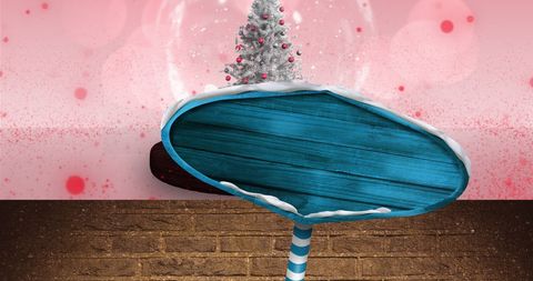 Festive road sign with christmas snow globe on pink background