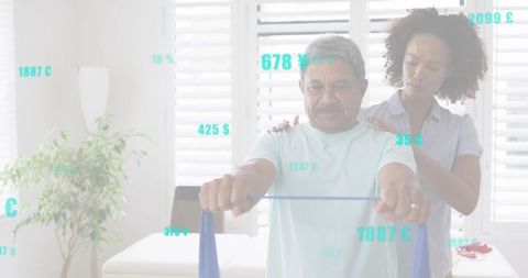 Senior man doing resistance band shoulder exercise with caregiver support in living room