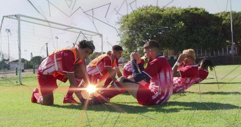Teen Soccer Players Exercising Together in Sunlit Park