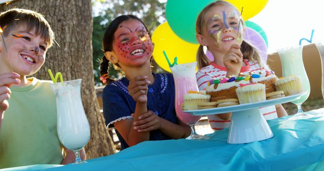 Children Enjoying Outdoor Birthday Party with Face Painting and Sweet Treats - Download Free Stock Images Pikwizard.com