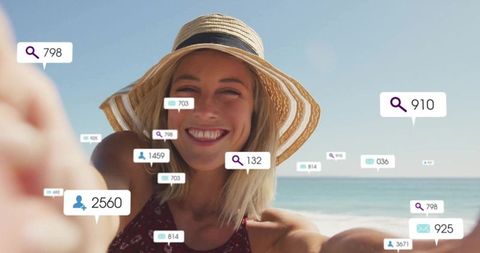 Woman in Sun Hat Taking Selfie on Beach with Social Media Icons