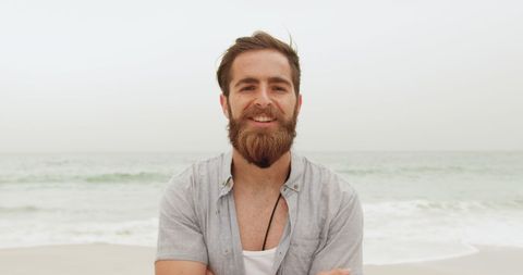 Relaxed Young Man Smiling on Beach with Sectored Hair and Beard - Download Free Stock Images Pikwizard.com