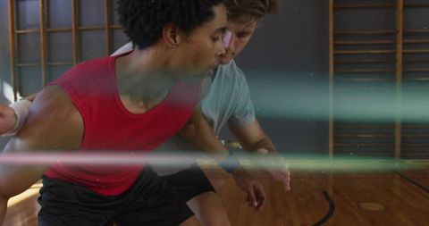 Athletes practicing basketball skills in school gym