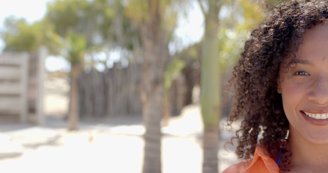 Happy Woman with Curly Hair Outdoors in Sunny Weather - Download Free Stock Images Pikwizard.com