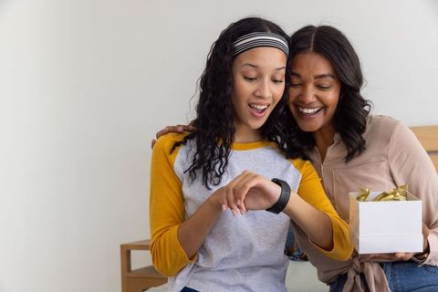Teen Daughter Receives Smartwatch Gift from Smiling Mother