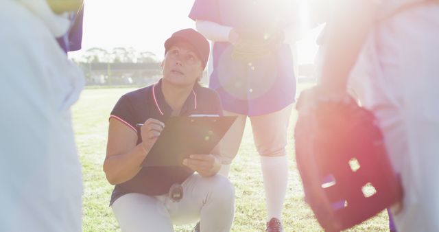 Baseball Coach Discussing Strategy with Young Team on Sunny Day - Download Free Stock Images Pikwizard.com