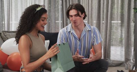 Interracial Couple Celebrating Birthday with Gifts Amid Festive Decor