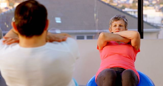 Senior Woman Exercising with Physioball in Fitness Class - Download Free Stock Images Pikwizard.com