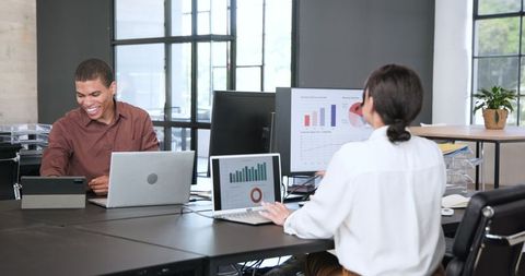 Multiracial colleagues collaborating on business project in modern office