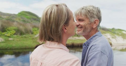 Senior Couple Embracing by River in Nature - Download Free Stock Images Pikwizard.com