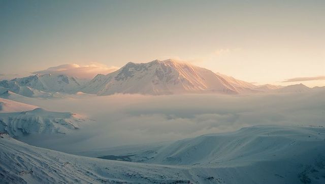 Misty Mountain Peak at Sunrise with Soft Glowing Light