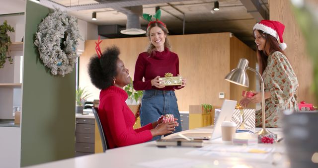 Diverse Female Colleagues Exchanging Christmas Gifts in Office - Download Free Stock Images Pikwizard.com