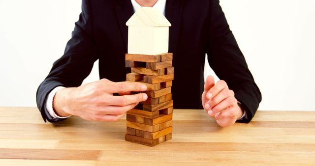 Businessman Playing Jenga with House Model - Download Free Stock Images Pikwizard.com
