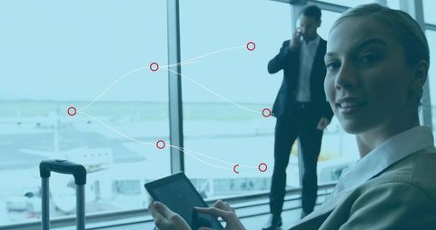 Businesswoman Using Tablet Device at Airport Terminal