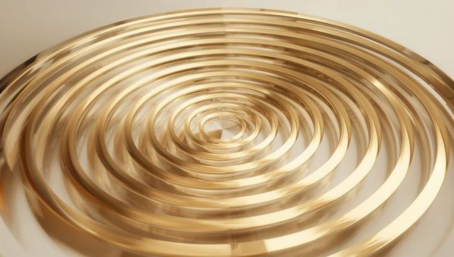 Polished gold concentric ring spiral sculpture reflecting soft highlights and gloss