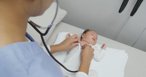 Nurse Conducting Newborn Health Check in Hospital