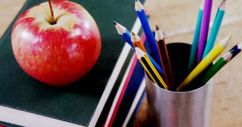 Apple on Books Stack with Pencils Symbolizing Education - Download Free Stock Images Pikwizard.com