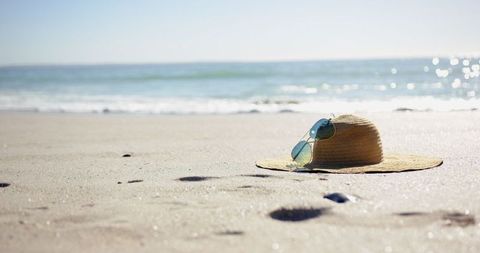 Tranquil Summer Beach with Straw Hat and Sunglasses - Download Free Stock Images Pikwizard.com