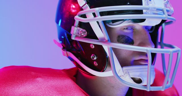 Image of portrait of caucasian american football player in helmet over neon purple background. American football, sports and competition concept.