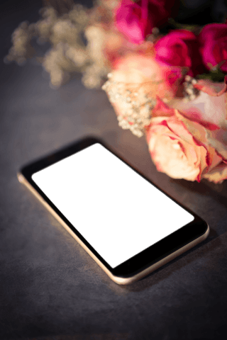 Transparent smartphone display beside elegant rose bouquet