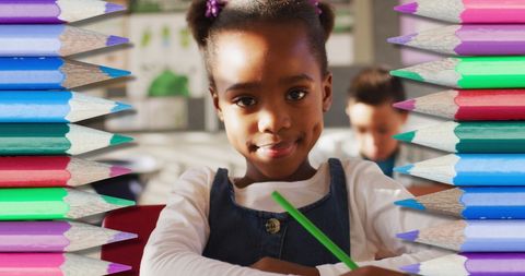 Young Student Drawing with Colorful Pencils in Classroom