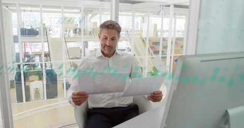 Business Professional Analyzing Reports in Modern Office