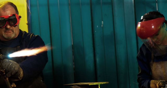 Industrial welders at work wearing protective gear in factory workshop - Download Free Stock Images Pikwizard.com