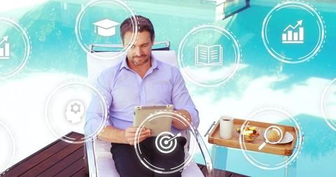 Businessman relaxing poolside while working on tablet with breakfast tray and productivity icons