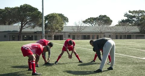 Soccer coach guides team during outdoor practice session