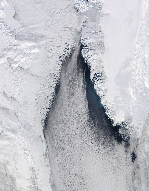 The late winter sun shone brightly on a stunning scene of clouds and ice in the Davis Strait in late February, 2013. The Moderate Resolution Imaging Spectroradiometer aboard NASA’s Aqua satellite captured this true-color image on February 22 at 1625 UTC.  The Davis Strait connects the Labrador Sea (part of the Atlantic Ocean) in the south with Baffin Bay to the north, and separates Canada, to the west, from Greenland to the east.  Strong, steady winds frequently blow southward from the colder Baffin Bay to the warmer waters of the Labrador Sea. Over ice, the air is dry and no clouds form. However, as the Arctic air moves over the warmer, open water the rising moist air and the temperature differential gives rise to lines of clouds. In this image, the clouds are aligned in a beautiful, parallel pattern. Known as “cloud streets”, this pattern is formed in a low-level wind, with the clouds aligning in the direction of the wind.  Credit: NASA/GSFC/Jeff Schmaltz/MODIS Land Rapid Response Team  <b><a href="http://www.nasa.gov/audience/formedia/features/MP_Photo_Guidelines.html" rel="nofollow">NASA image use policy.</a></b>  <b><a href="http://www.nasa.gov/centers/goddard/home/index.html" rel="nofollow">NASA Goddard Space Flight Center</a></b> enables NASA’s mission through four scientific endeavors: Earth Science, Heliophysics, Solar System Exploration, and Astrophysics. Goddard plays a leading role in NASA’s accomplishments by contributing compelling scientific knowledge to advance the Agency’s mission.  <b>Follow us on <a href="http://twitter.com/NASA_GoddardPix" rel="nofollow">Twitter</a></b>  <b>Like us on <a href="http://www.facebook.com/pages/Greenbelt-MD/NASA-Goddard/395013845897?ref=tsd" rel="nofollow">Facebook</a></b>  <b>Find us on <a href="http://instagram.com/nasagoddard?vm=grid" rel="nofollow">Instagram</a></b>