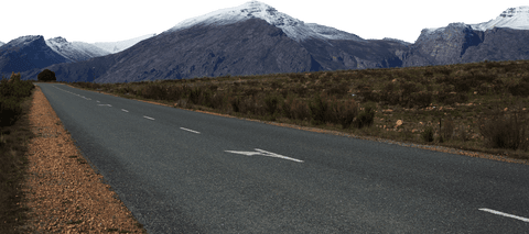 Transparent mountain road scene with snowcapped peaks