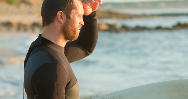 Man Preparing for Surfing at Sunrise Ocean Beach - Download Free Stock Images Pikwizard.com