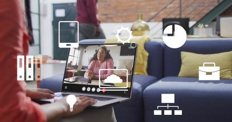 Colleagues engaged in digital meeting with virtual icons overlay