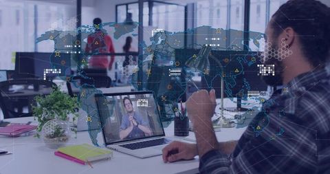 Remote worker joining video call with holographic world map overlay in modern office