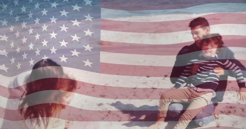 Family relaxing on sandy beach with faded american flag overlay for patriotic lifestyle