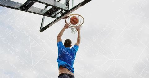 Jumping basketball player dunking toward hoop with geometric math overlay against sky