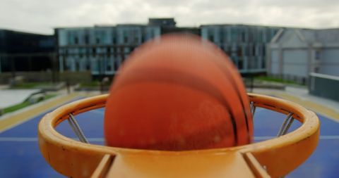 Close-Up Action Shot of Basketball Scoring a Hoop Outdoors