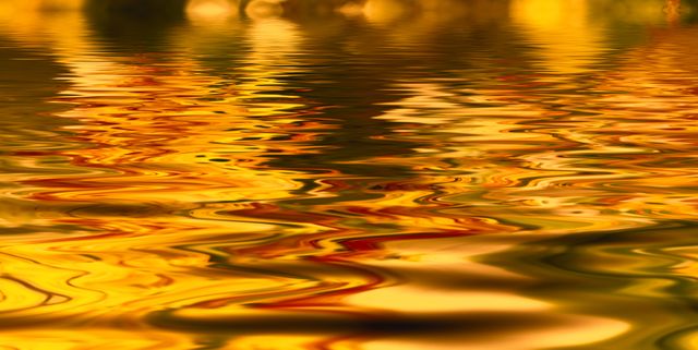 This captivating image depicts the vibrant colors of autumn reflecting off the water's surface, creating a stunning abstract pattern. Ideal for use in seasonal promotions, nature-related blogs, meditation apps, or as an eye-catching background for websites and digital displays.