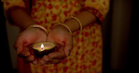 Close-up of Woman Holding Lit Diya During Festival Celebration