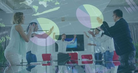 Business Team Celebrating with Data Visualization Overlay