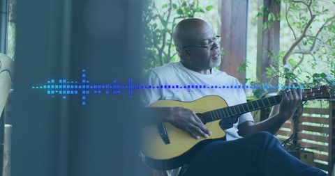 Senior Man Enjoying Guitar Music on Home Terrace