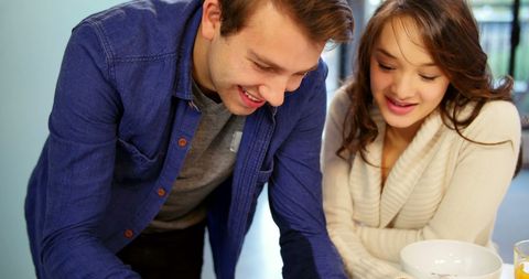 Couple Using Digital Tablet in Cozy Living Room