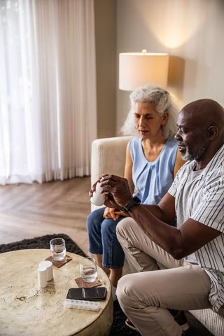 Senior Couple Organizing Medication at Home in Cozy Setting