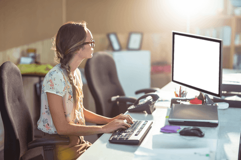 woman sitting at desk working on computer with transparent screen - Download Free Stock Videos Pikwizard.com