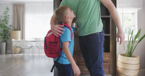 Father and Son Embracing in Bright Living Room