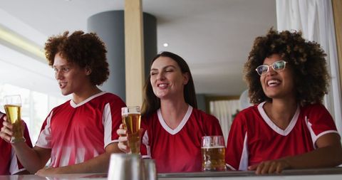 Diverse Friends Celebrating Game With Toast in Bar