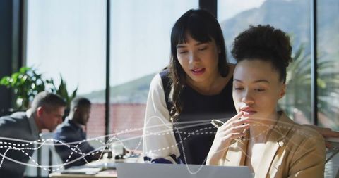 Business Women Collaborating on Innovative Project