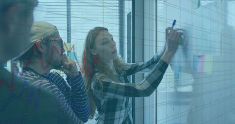 Business Team Brainstorming Data Analysis on Glass Board